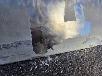 Partially cleaned stainless steel surface.
